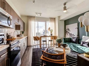 a living room and kitchen with a couch and a table